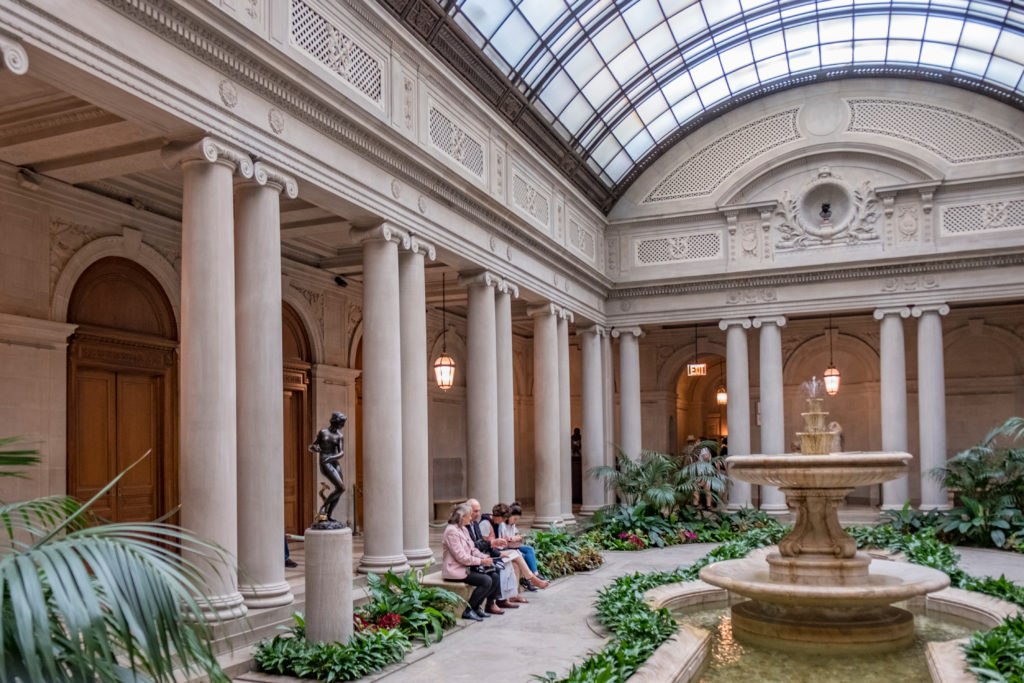 NEW YORK CITY - APRIL 17, 2016: people rest in the atrium of the Frick Collection, former 5th Avenue mansion of steel magnate Henry Clay Frick.