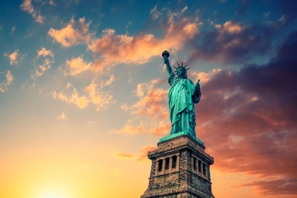 New York City, The Statue of Liberty at sunset with a beautiful vanilla sky.