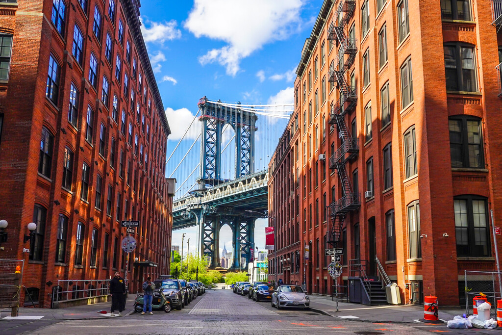 BROOKLYN, NEW YORK - MAY 4, 2020: Iconic Manhattan Bridge and Empire State Building view from Washington Street in Brooklyn, New York