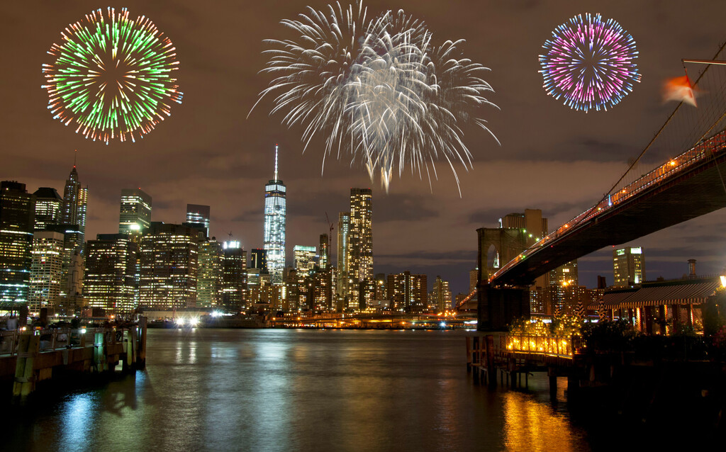 Fireworks over New York City skyline and Brooklyn Bridge