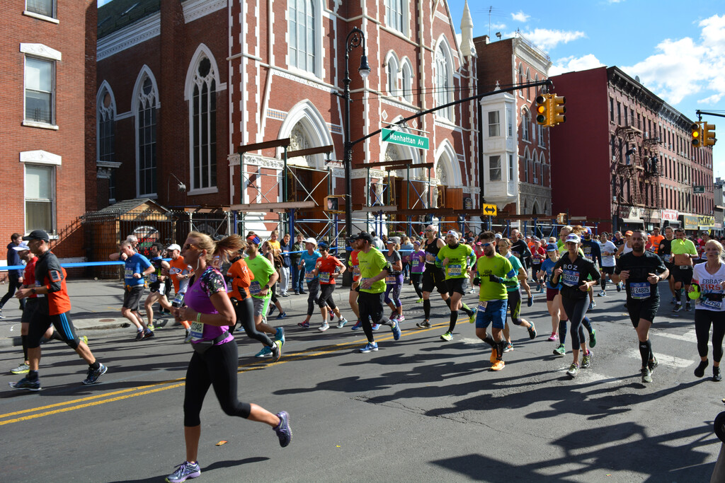 New York City Marathon on Manhattan Avenue at Milton Street in Greenpoint, Brooklyn with the Church of Saint Anthony in the Background - November 6, 2016.