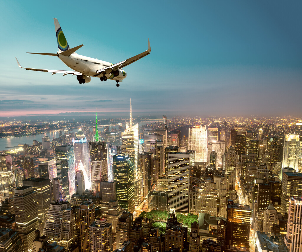 Airplane landing at night in New York City.