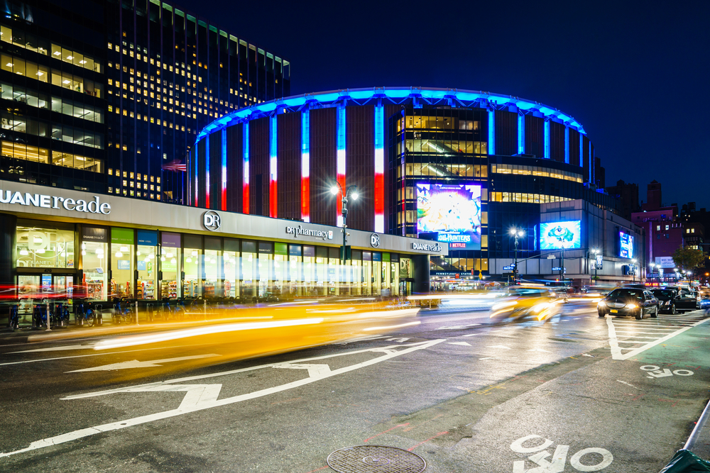 Madison Square Garden, New York, USA - 17 October, 2016: Illuminated stadium with car riding around.